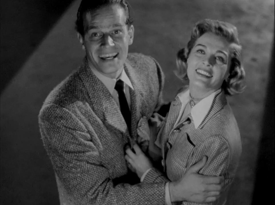 Charlton Heston and Lizabeth Scott smiling during the surprisingly upbeat ending of the 1950 noir, Dark City, from which Eddie Muller took the name of his book.