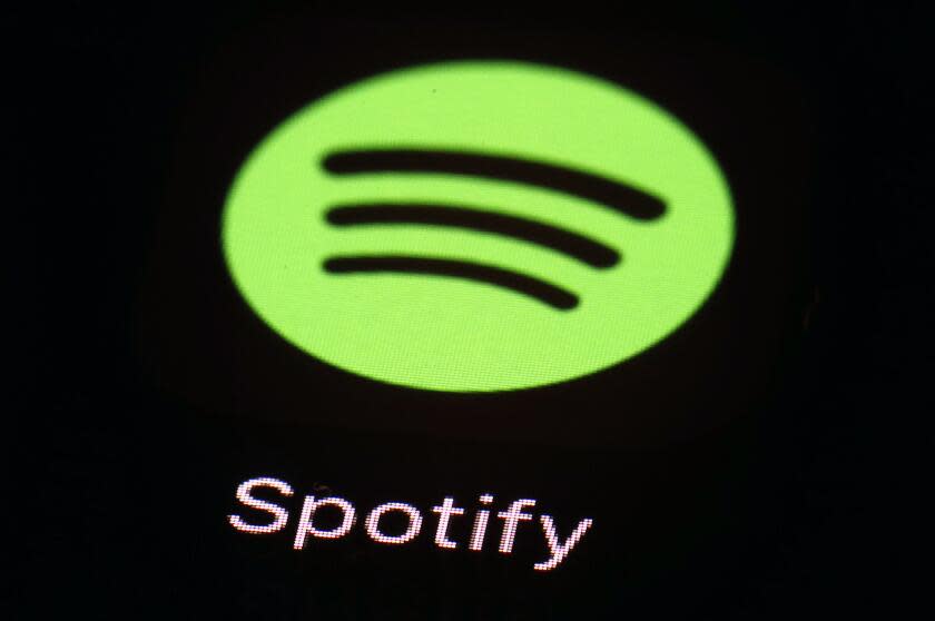 FILE- This March 20, 2018 file photo shows the Spotify app on an iPad in Baltimore. Music streaming service Spotify says it's cutting 6% of its workforce, becoming yet another tech company resorting to layoffs as the economic outlook worsens. CEO Daniel Ek announced the restructuring in a message to employees that was also posted online Monday, Jan. 23, 2023. (AP Photo/Patrick Semansky, File)