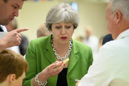 Britain's Prime Minister Theresa May samples cheese at the Royal Bath and West Show in Shepton Mallet, May 31, 2017. REUTERS/Leon Neal/Pool