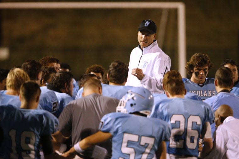Saint Joseph coach Ben Downey talks with his players before the beginning of the second half of a high school football game on Friday, Sept. 20, 2013, at Saint Joseph High School in downtown South Bend. SBT Photo/JAMES BROSHER