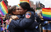 <p>Member of the NYFD kiss each other after a propose to get married while they attend the annual gay parade on June 24, 2018 in New York City. (Photo: Kena Betancur/Getty Images) </p>