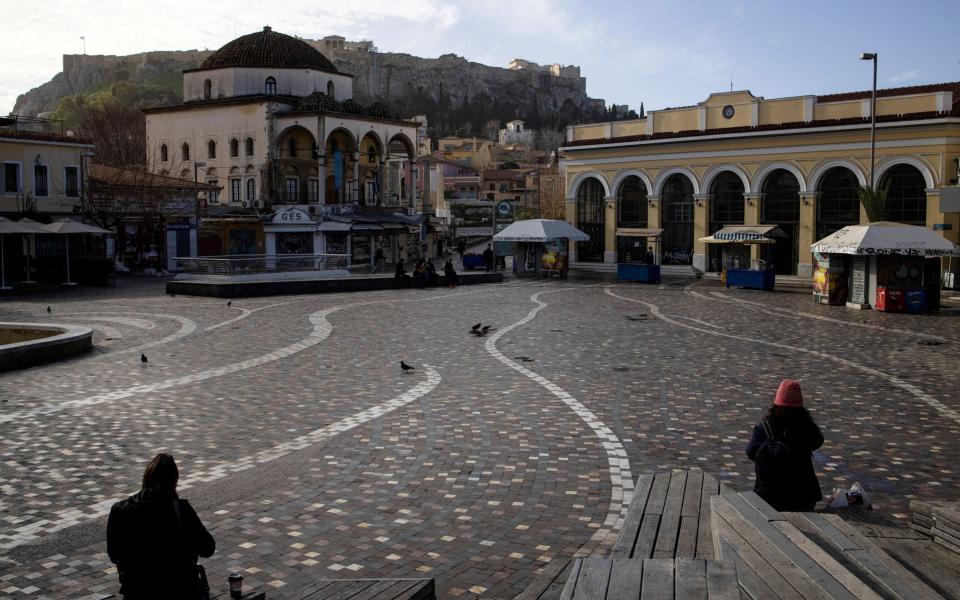 People sit in Monastiraki square after the Greek government imposed stricter lockdown measures against the coronavirus pandemic, in Athens - Reuters