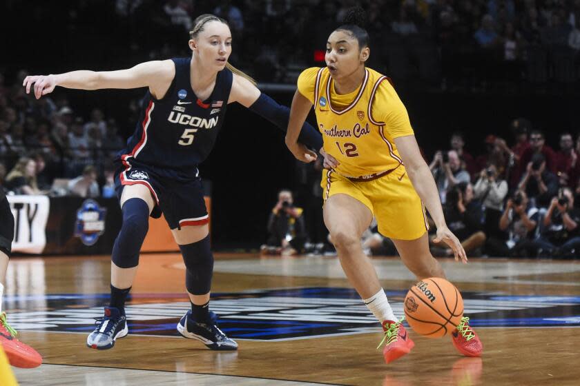 Southern California guard JuJu Watkins (12) drives to the basket past UConn guard Paige Bueckers.