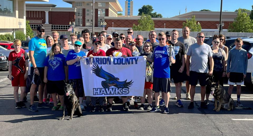 Marion County Special Olympics athletes and area law enforcement officers took time for a photo prior to the start of the annual Law Enforcement Torch Run on Friday, June 24, 2022.