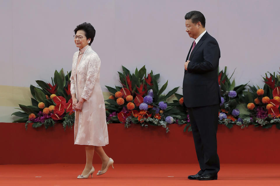 FILE - Chinese President Xi Jinping, right, looks at Hong Kong's new Chief Executive Carrie Lam after administering the oath for a five-year term in office at the Hong Kong Convention and Exhibition Center in Hong Kong on July 1, 2017. Xi will visit Hong Kong this week to celebrate the 25th anniversary of the former British colony's 1997 return to China, a state news agency said Saturday, June 25, 2022, in his first trip outside the mainland since the start of the coronavirus pandemic 2 1/2 years ago. (AP Photo/Kin Cheung, File)