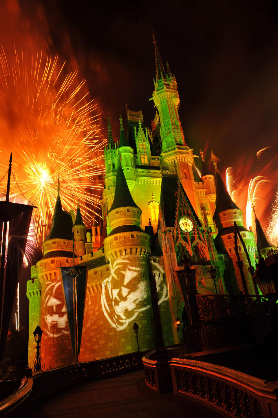 This undated image released by Disney shows orange fireworks exploding over Cinderella's Castle while illuminated pumpkins are projected with light during the "Happy HalloWishes" fireworks show at Magic Kingdom in Lake Buena Vista, Fla. (AP Photo/Disney, Gene Duncan)