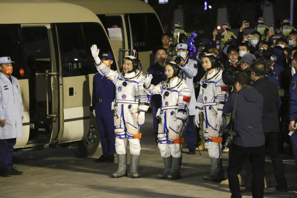 From left, Chinese astronauts Zhai Zhigang, Wang Yaping, and Ye Guangfu, wave before leaving for the Shenzhou-13 crewed space mission at the Jiuquan Satellite Launch Center in northwest China, Oct. 15, 2021. Shortly ahead of sending a new three-person crew to its space station, China on Friday renewed its commitment to international cooperation in the peaceful use of space. (Chinatopix Via AP) CHINA OUT