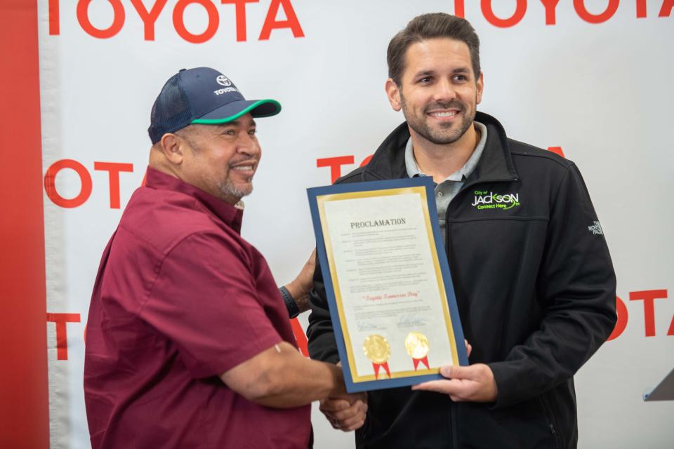 Mayor Scott Conger poses for a photo with Toyota team leader John Collins as Conger declare it Toyota Tennessee Dat in Jackson, Tenn., on Friday, Nov. 3, 2023.