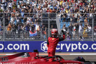 Ferrari driver Charles Leclerc of Monaco salutes spectators after getting pole position during qualifying for the Formula One Miami Grand Prix auto race at the Miami International Autodrome, Saturday, May 7, 2022, in Miami Gardens, Fla. (AP Photo/Darron Cummings)