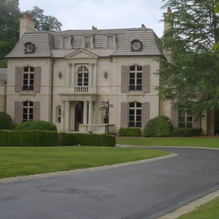 The long driveway leads to the elegant mansion
