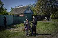 Villagers wait for aid distribution by Kharkiv's Red Cross in the village of Staryi Saltiv, east Kharkiv, Ukraine, Friday, May 20, 2022. The village formerly occupied by Russian forces is back under Ukrainian control, albeit very close to the front line and under constant shelling. (AP Photo/Bernat Armangue)