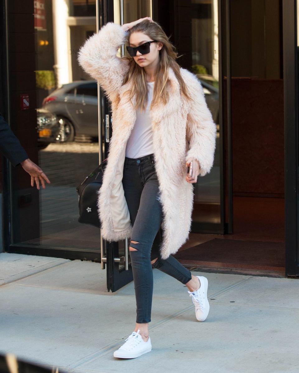 <p>Out in New York City wearing a pale pink faux-fur coat with a white tee and distressed Parker Smith jeans, plus Converse sneakers and Elizabeth and James sunglasses. </p>