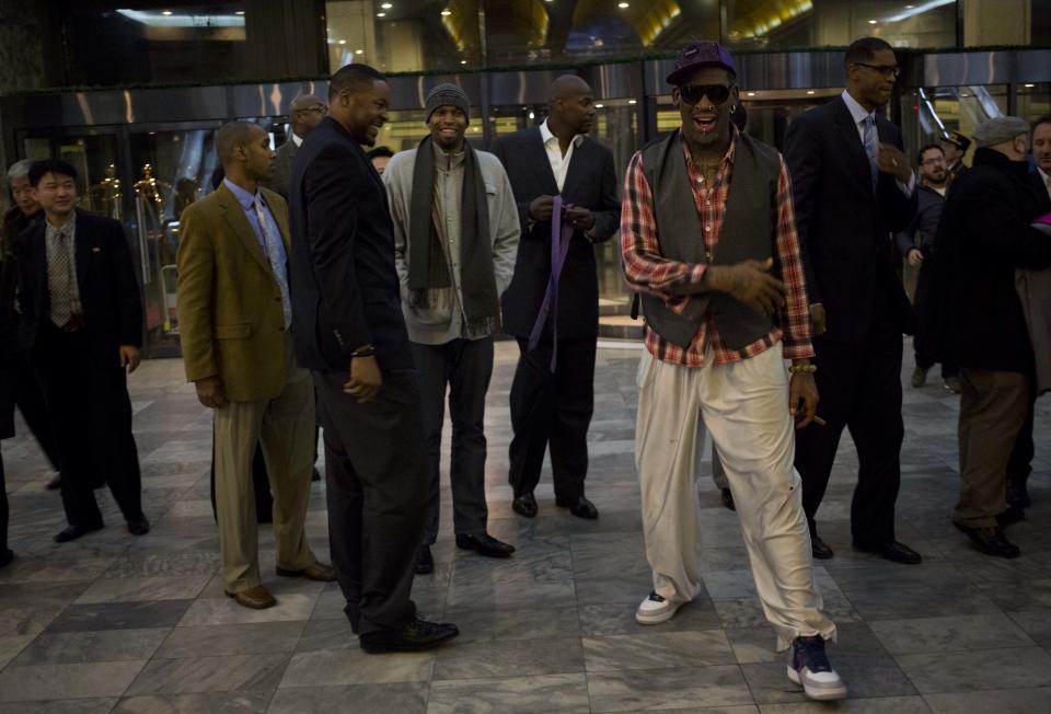 Former NBA basketball star Dennis Rodman, foreground right, and fellow U.S. basketball players arrive at a hotel in Pyongyang, North Korea after returning from an official dinner on Monday, Jan. 6, 2014. Rodman arrived in the North Korean capital with a squad of former basketball stars in what he calls "basketball diplomacy," although U.S. officials have criticized his efforts. (AP Photo/David Guttenfelder)