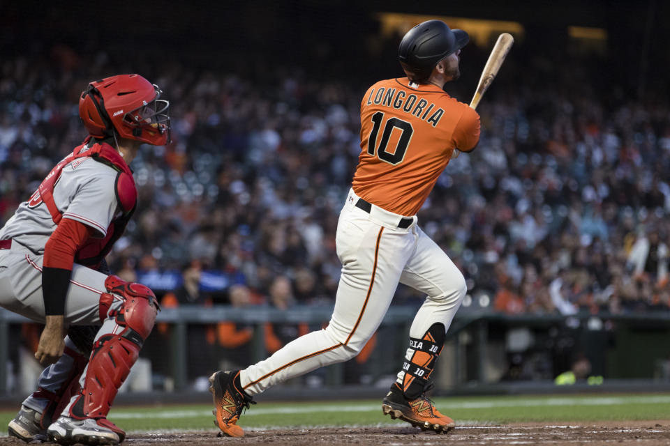 San Francisco Giants' Evan Longoria watches his solo home run next to Cincinnati Reds catcher Aramis Garcia during the fourth inning of a baseball game in San Francisco, Friday, June 24, 2022. (AP Photo/John Hefti)