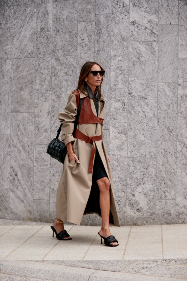 A showgoer carrying a Bottega Veneta bag and wearing Bottega Veneta shoes during Milan Fashion Week in September 2019. 