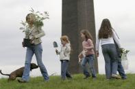 <p>Newton-John plays with children at a Sydney park during National Tree Day. She was a passionate conservationist and activist and advocated on behalf of endangered animals and nature in general throughout her whole life.</p>