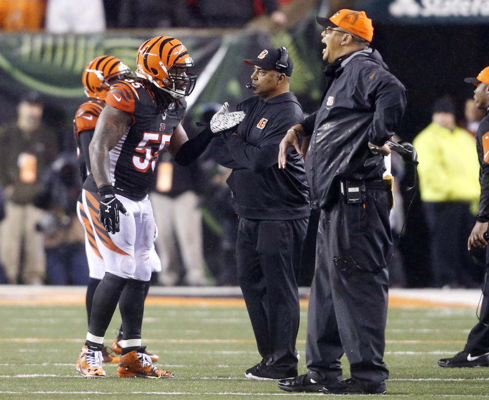 FILE - In this Jan. 10, 2016, file photo, Cincinnati Bengals head coach Marvin Lewis, center, talks with outside linebacker Vontaze Burfict (55) after a penalty during the second half of an NFL wild-card playoff football game against the Pittsburgh Steelers in Cincinnati. The Bengals had two 15-yard penalties that helped the Steelers win a playoff game at Paul Brown Stadium in the 2015 season. They set a club record with 173 yards in penalties as Pittsburgh rallied to pull another one out last December. The theme for this week: Keep cool when the Steelers come to town again. (AP Photo/Frank Victores, File)
