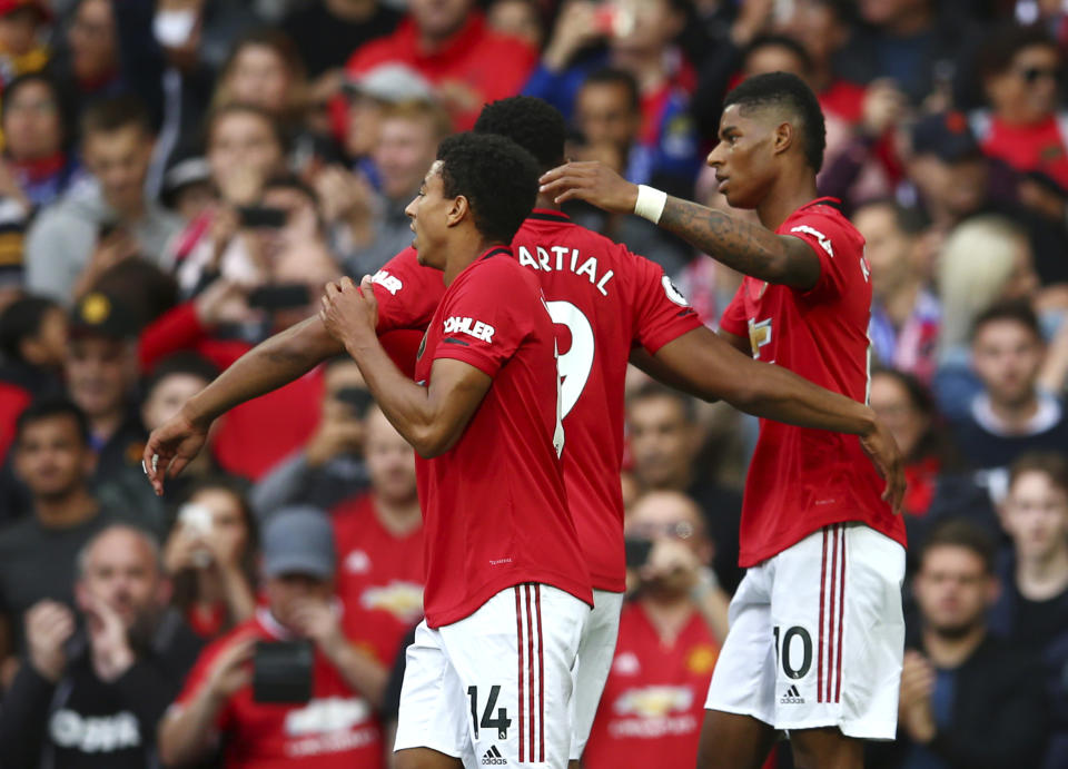 Manchester United's Marcus Rashford, right, celebrates with teammates after scoring his sides first goal during the English Premier League soccer match between Manchester United and Chelsea at Old Trafford in Manchester, England, Sunday, Aug. 11, 2019. (AP Photo/Dave Thompson)