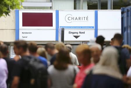 People wait outside the university clinic in Steglitz, a southwestern district of Berlin, July 26, 2016 after a doctor had been shot at and the gunman had killed himself. REUTERS/Hannibal Hanschke