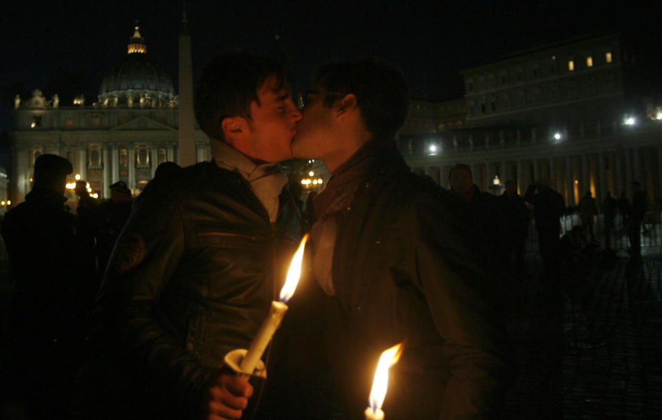 FILE - In this Saturday Dec. 6, 2008 file photo two men kiss each other outside St. Peter's Square at the Vatican during a candle-lit demonstration for gay rights. Pope Francis endorsed same-sex civil unions for the first time as pope while being interviewed for the feature-length documentary "Francesco," which premiered Wednesday, Oct. 21 2020 at the Rome Film Festival. (AP Photo/Alessandra Tarantino, File)