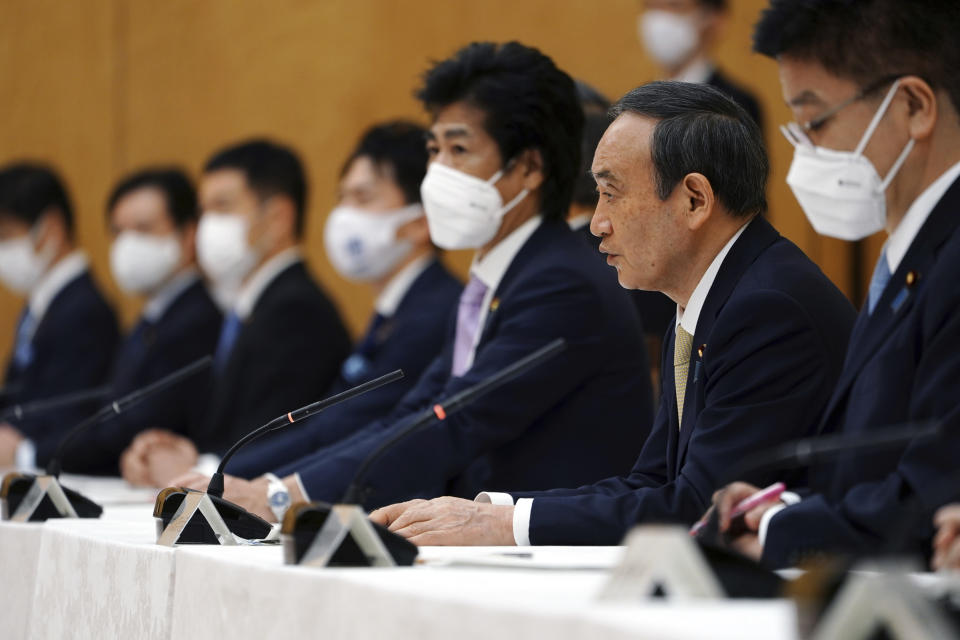 Japanese Prime Minister Yoshihide Suga, second right, declares a state of emergency for Tokyo and three other prefectures during the government task force meeting for the COVID-19 measures at the prime minister's office Friday, April 23, 2021, in Tokyo. (AP Photo/Eugene Hoshiko, Pool)