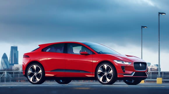 A red Jaguar I-Pace, a sleek red SUV with elements of sports-sedan styling.