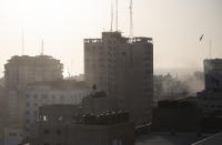 An Israeli missile flies down to hit a building in Gaza City, Wednesday, May 12, 2021. The Israeli airstrike was the latest in a series of assaults on targets in the Gaza Strip after a long dispute between Israel and Hamas erupted into an exchange of rocket attacks from Gaza and Israeli retaliation. (AP Photo/Khalil Hamra)