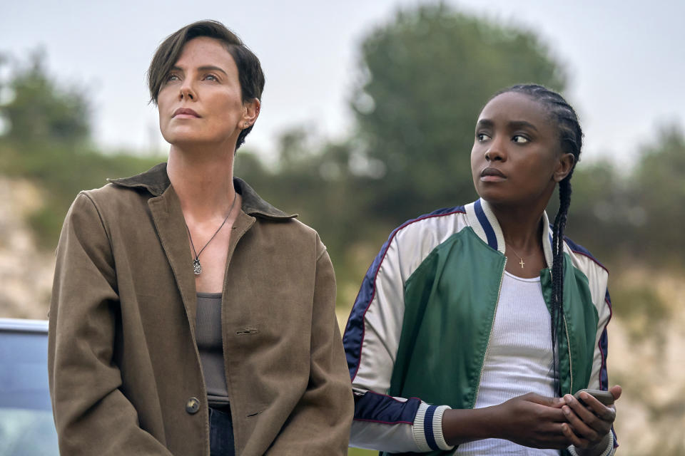 This image released by Netflix shows Charlize Theron, left, and Kiki Layne in a scene from "The Old Guard," premiering July 10 on Netflix. (Aimee Spinks/Netflix via AP)