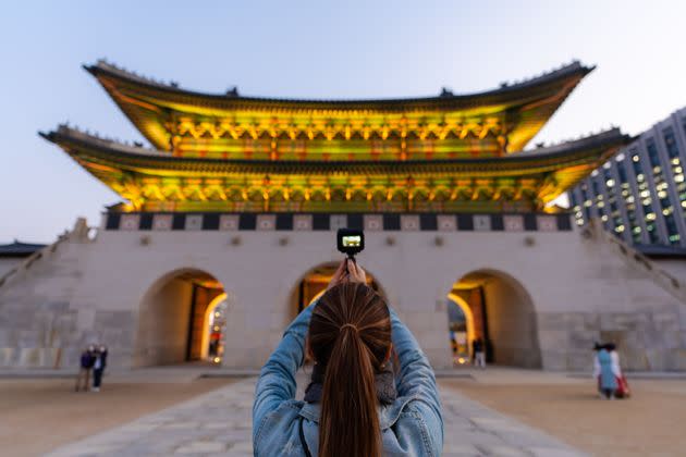 Rear view of woman enjoying travel at Gyeongbokgung Palace in Seoul, South Korea