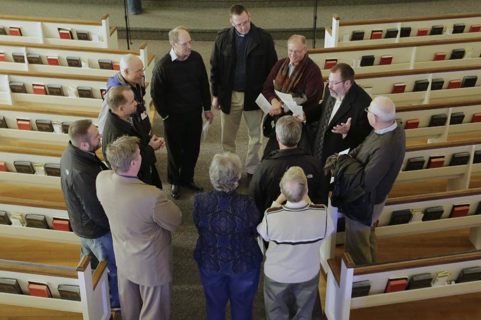 In this Thursday, Feb. 6, 2014 photo, religious leaders of various denominations in Fremont, Neb., meet at the First United Methodist Church, following a service, part of 40 Days of Prayer for Fremont. The prayer and meeting comes ahead of a special election Tuesday, Feb. 11, to decide whether to drop housing restrictions against illegal immigrants, as had been approved by Fremont voters in the 2010 elections. The city leaders scheduled the special election because of concerns the housing restrictions could cost them millions in federal grants and lead to more lawsuits against the city. (AP Photo/Nati Harnik)