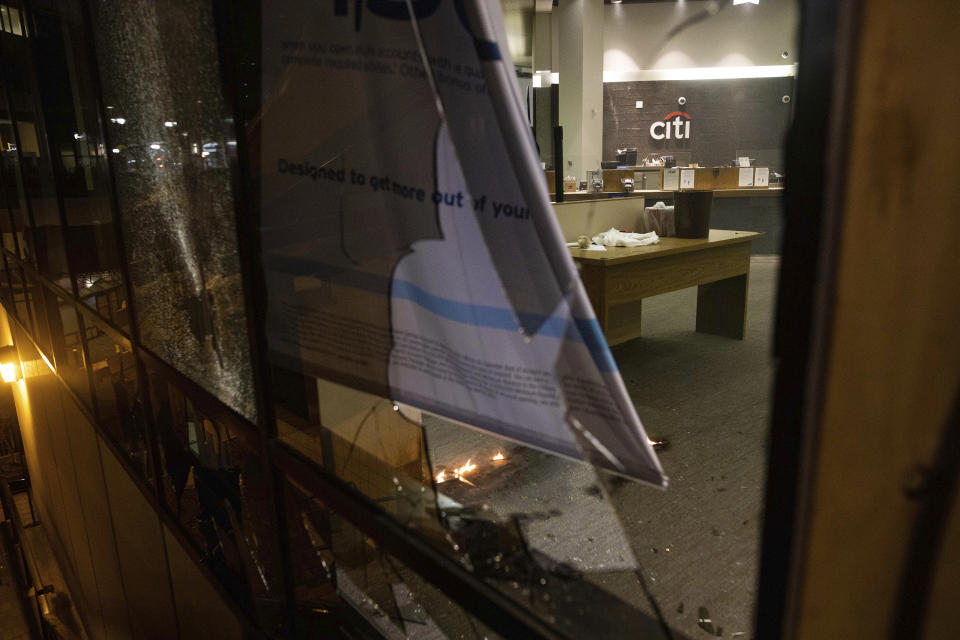 A Citibank is vandalized during a protest on Saturday, July 25, 2020, in Oakland, Calif. Protesters in California set fire to a courthouse, damaged a police station and assaulted officers after a peaceful demonstration intensified late Saturday, Oakland police said. (AP Photo/Christian Monterrosa)