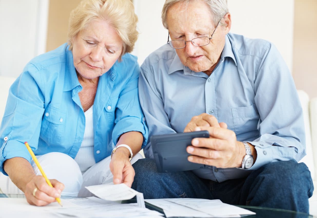 senior couple calculating their personal finances at home