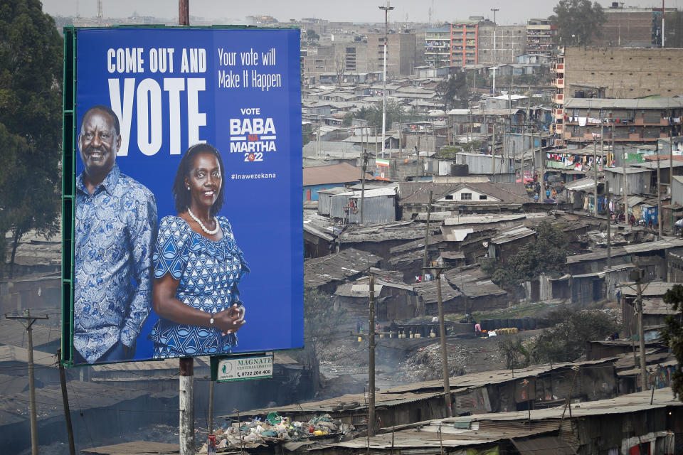 A billboard asking Kenyans to vote for Kenyan presidential candidate Raila Odinga, referred to affectionately as "Baba", the Swahili word for "father", and his running mate Martha Karua, rises above shacks in the low-income Mathare neighborhood of Nairobi, Kenya Friday, July 29, 2022. Kenya's Aug. 9 election is ripping open the scars of inequality and corruption as East Africa's economic hub chooses a successor to President Uhuru Kenyatta. (AP Photo/Brian Inganga)