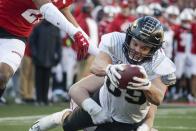 FILE - In this Nov. 23, 2019, file photo, Purdue's Brycen Hopkins dives into the end zone for a touchdown during the first half of an NCAA college football game against Wisconsin, in Madison, Wis. Hopkins was selected to The Associated Press All-Big Ten Conference team, Wednesday, Dec. 11, 2019. (AP Photo/Morry Gash, File)