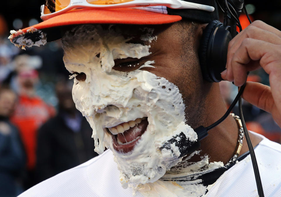 Baltimore Orioles' Nelson Cruz reacts after teammate Adam Jones smeared a pie in his face during a postgame television interview after an opening day baseball game against the Boston Red Sox, Monday, March 31, 2014, in Baltimore. Baltimore won 2-1 on a solo home run by Cruz. (AP Photo/Patrick Semansky)