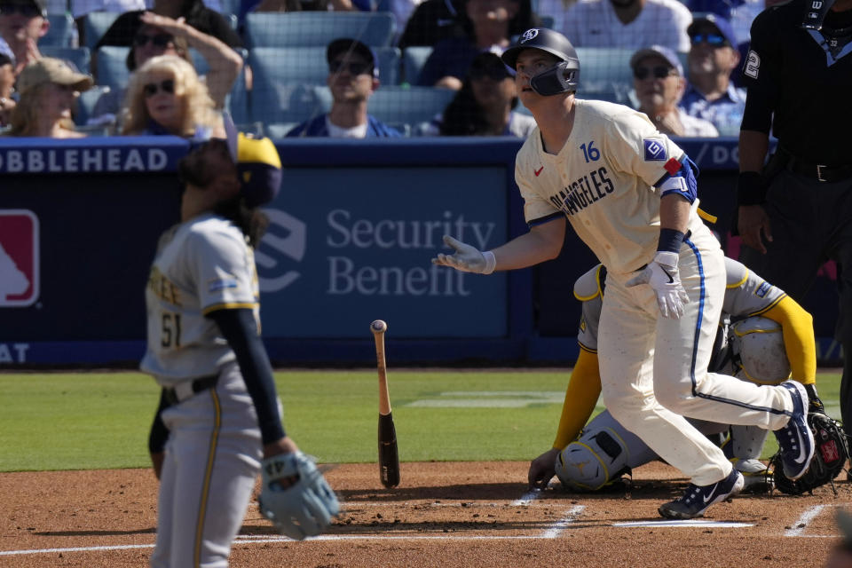 Los Angeles Dodgers' Will Smith, right, heads to first for a two-run home run as Milwaukee Brewers starting pitcher Freddy Peralta watches during the first inning of a baseball game Saturday, July 6, 2024, in Los Angeles. (AP Photo/Mark J. Terrill)