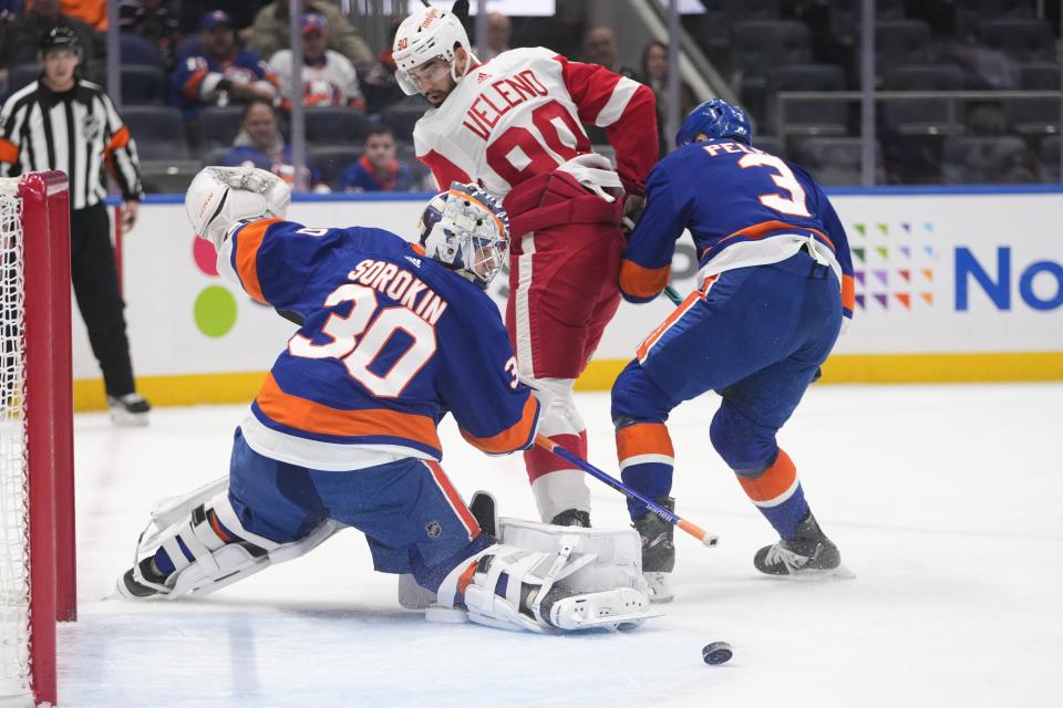 New York Islanders' Ilya Sorokin (30) stops a shot on goal by Detroit Red Wings' Joe Veleno (90) as treammate Adam Pelech (3) defends during the first period at UBS Arena in Elmont, New York, on Friday, Jan. 27, 2023.