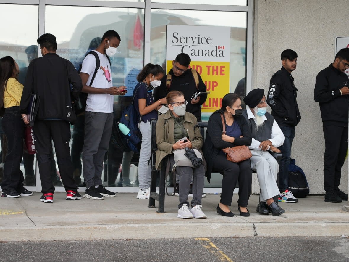 Hundreds of people started lining up outside a Service Canada office in Brampton, Ont., at 5 a.m. on Thursday and had to wait for hours. Many international students were in line hoping to receive a Social Insurance Number to be able to work in Canada.  (Paul Smith/CBC - image credit)