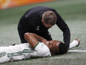 Portland Timbers forward Jeremy Ebobisse (17) is checked by a member of the medical staff after being injured during the first half of the MLS Cup championship soccer game against Atlanta United, Saturday, Dec. 8, 2018, in Atlanta. (AP Photo/John Bazemore)