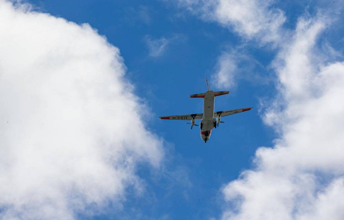 A United States Coast Guard airplane flys over the U.S. Customs and Border Protection office on Sunday, Jan. 8, 2023, in Marathon, Fla.