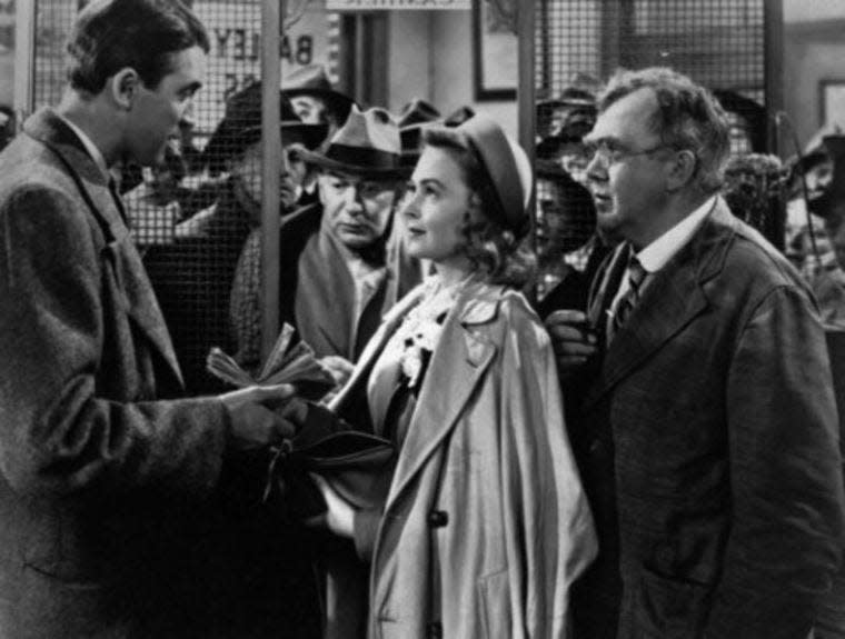 'It's a Wonderful Life," 1946.  James Stewart, left, Thomas Mitchell, right, and Donna Reed try to calm the panicked townspeople who have made a run on the Bailey Building and Loan." "We can get through this thing all right if we stick together. We've got to have faith in each other."