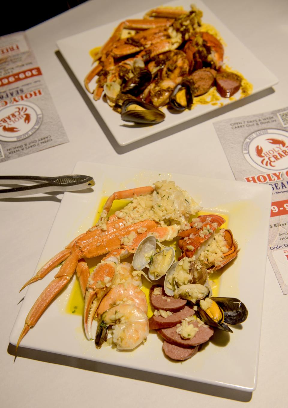 A sampler of Holy Crab's seafood boil includes snow crab, mussels, shrimp, lobster tail and sausage in a variety of sauces like garlic butter and Cajun sauce.