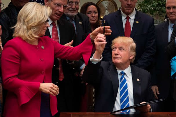 PHOTO: FILE - US President Donald Trump gives a pen to US Congresswoman Liz Cheney at the White House in Washington, DC, March 27, 2017. (Jim Watson/AFP via Getty Images, FILE)