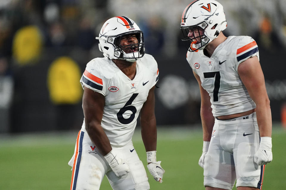 Virginia's Nick Johnson (6) and James Jackson (7) celebrate after the team's win over Georgia Tech in an NCAA college football game Thursday, Oct. 20, 2022, in Atlanta. (AP Photo/John Bazemore)