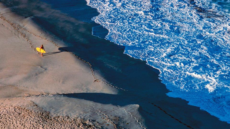 Oahu, North Shore, aerial view of winter waves and surfer at Waimea Bay