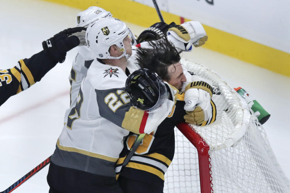 Boston Bruins left wing Brad Marchand is slammed into the goal by Vegas Golden Knights defenseman Nick Holden (22) during the third period of an NHL hockey game in Boston, Tuesday, Jan. 21, 2020. (AP Photo/Charles Krupa)