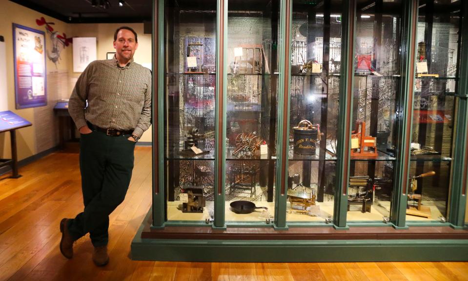 Chris Cascio, a curator overseeing the Hagley Museum's nearly 5,000 patent models, stands with some of the inventions in miniature on display at the exhibit "Nation of Inventors," Tuesday, Dec. 6, 2022. Jeopardy! will give the collection prime time exposure in the category "World of Patent Models" in Thursday's broadcast.