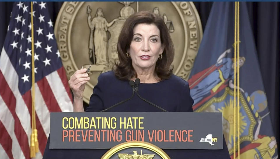 FILE - In this image taken from video, New York Gov. Kathy Hochul shows bullets similar to those used in the Buffalo supermarket shooting, during a news conference, Wednesday, May 18, 2022, in New York. New York lawmakers are moving this week on a package of bills that include raising the minimum age to purchase or possess a semiautomatic rifle from 18 to 21. (Office of the Governor of New York via AP)