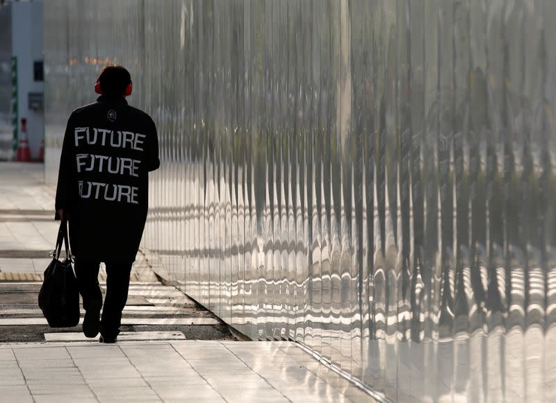 A man makes his way in a business district in Tokyo