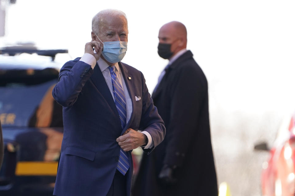 President-elect Joe Biden puts his finger on his ear as reporters shout question to him as he arrives at The Queen theater in Wilmington, Del., Monday, Dec. 7, 2020. (AP Photo/Susan Walsh)